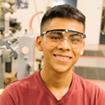 man wearing safety goggles in manufacturing setting
